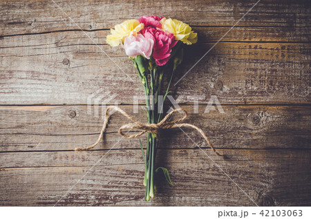 Carnation flowers on wooden table 42103063