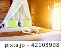 White towel and Chinese rose on bed 42103998