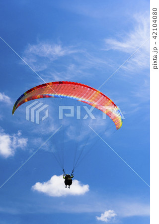 Paragliding extreme Sport with blue Sky and clouds Paragliding extreme Sport with blue Sky and clouds 42104080