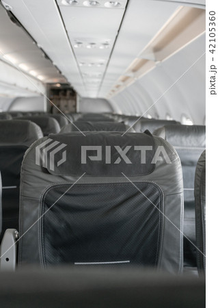 Empty airplane seats in the cabin. Modern Airplane seats in perspective. Transportation concept 42105360