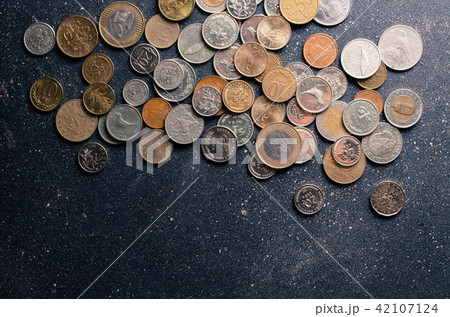 Different coins on dark background Different coins on dark background 42107124