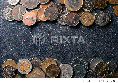 Different coins on dark background Different coins on dark background 42107126
