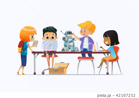 Boys and girls standing and sitting around desk with laptops and robot and working on school project 42107252