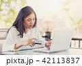 Asian women holding  credit card to payment  42113837