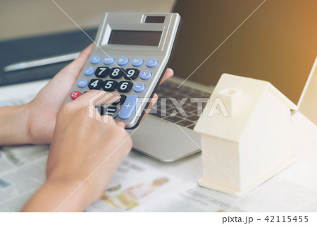 Woman accountant or bank worker uses calculator. 42115455