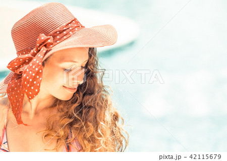 Happy young woman in swimsuit at swimming pool. 42115679
