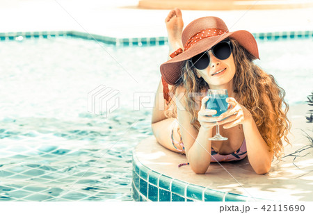 Happy young woman in swimsuit at swimming pool. 42115690