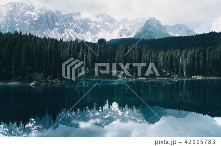 The Karersee lake with reflection of mountains in the Dolomites. 42115783