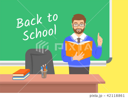 Teacher reads book near blackboard in classroom 42118861