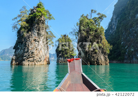 Limestone mountain ranges with long-tailed boat  42122072