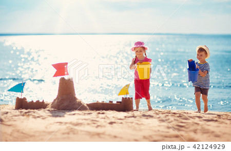 Boy and girl playing on the beach Boy and girl playing on the beach 42124929