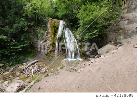 a small waterfall in a green coniferous forest. pl a small waterfall in a green coniferous forest. pl 42128099