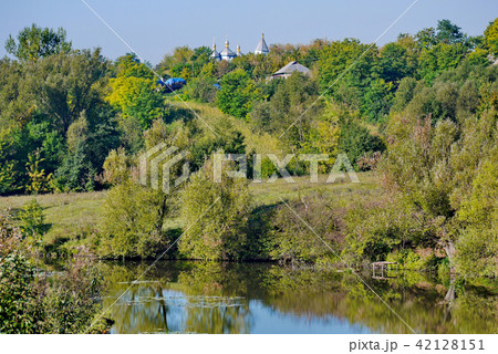 the domes of the village church rise above the gre 42128151