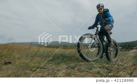 Fat bike also called fatbike or fat-tire bike in summer driving hills. Fat bike also called fatbike or fat-tire bike in summer driving hills. 42128990