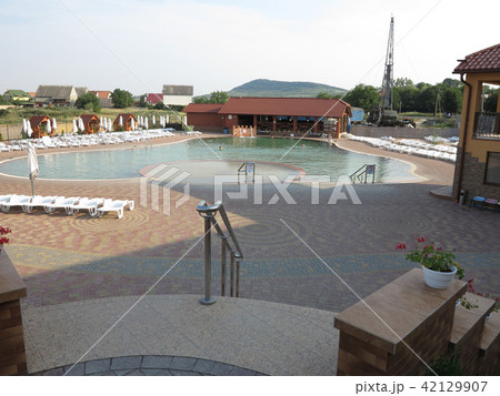 resort with a swimming pool, white sun loungers an resort with a swimming pool, white sun loungers an 42129907