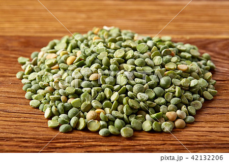 Pile of green peas on rustic wooden background, close-up, top view, selective focus. Pile of green peas on rustic wooden background, close-up, top view, selective focus. 42132206