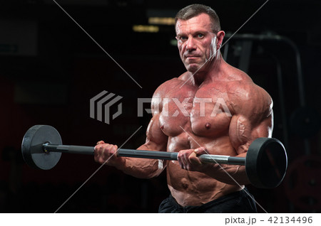 Strong mature bodybulding man in the gym Strong mature bodybulding man in the gym 42134496