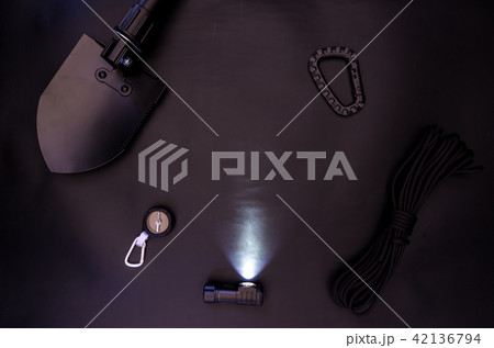 A glowing tourist lantern. Shovel and compass. A glowing tourist lantern. Shovel and compass. 42136794