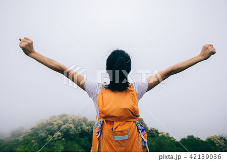 Happy woman  outstretched arms on  mountain valley 42139036