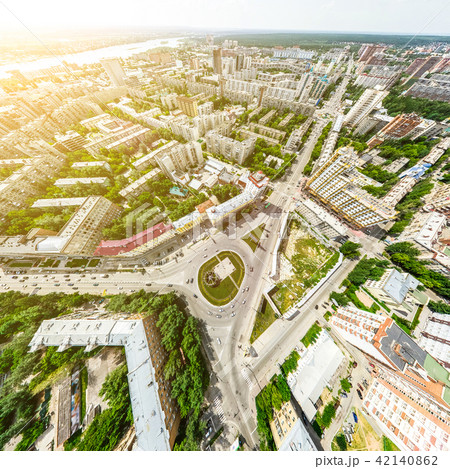 Aerial city view with crossroads and roads, houses, buildings, parks and parking lots. Sunny summer 42140862