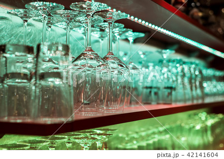 Crystal glass, row and Stack of different glass shelf behind the bar counter, and ready to use Crystal glass, row and Stack of different glass shelf behind the bar counter, and ready to use 42141604
