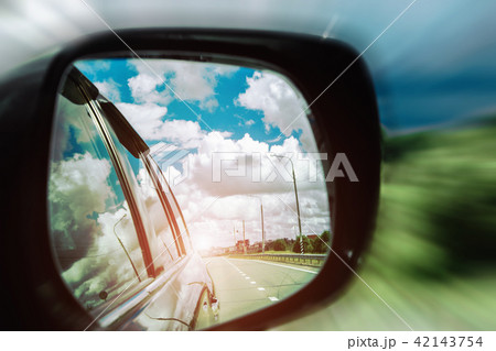 reflection of the road in the mirror of the car 42143754