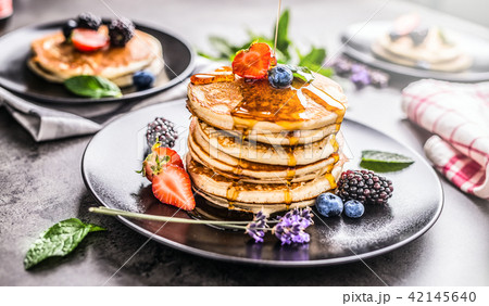 Pancakes with strawberries blackberries blueberrie 42145640