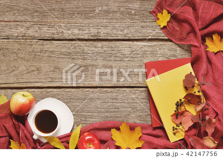Vintage Autumn table with apples, fallen leaves, vintage books, cup of coffee or tea on old wooden 42147756