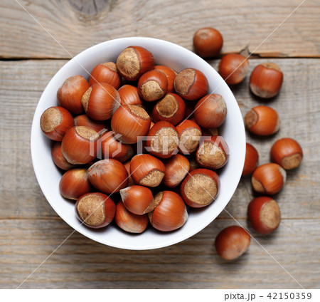 Hazelnuts close-up on wooden table 42150359