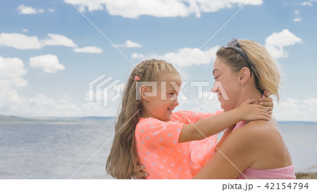 Little cute girl and young mother at beach. 42154794