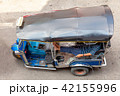 A tuk-tuk driver waits for customers on the street 42155996