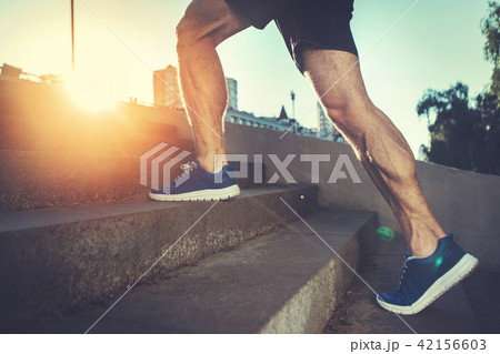 Athlete training on street in morning  42156603