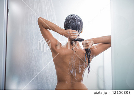 Young female enjoying warm shower Young female enjoying warm shower 42156803