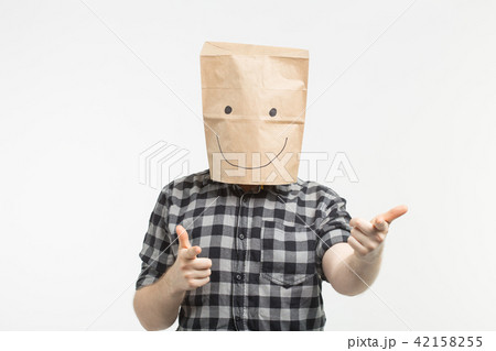 Portrait of man in happy paper bag mask on white background Portrait of man in happy paper bag mask on white background 42158255