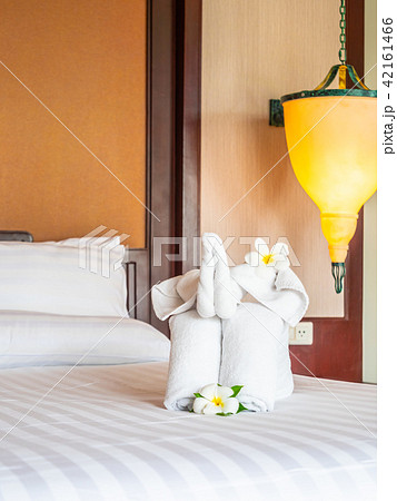 White elephant towel and comfortable pillow on bed White elephant towel and comfortable pillow on bed 42161466