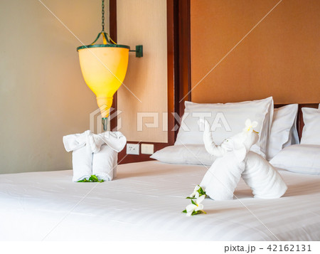 White elephant towel and comfortable pillow on bed White elephant towel and comfortable pillow on bed 42162131