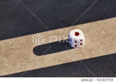 Closeup of a single white dice Closeup of a single white dice 42165759