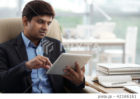 Businessman working on digital tablet 42166161