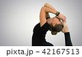 Woman doing stretching exercises, practicing yoga on white background 42167513