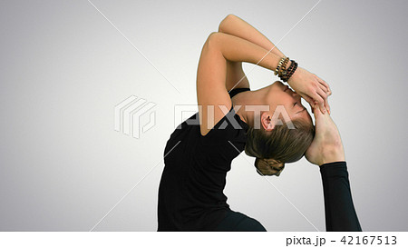 Woman doing stretching exercises, practicing yoga on white background 42167513