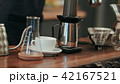 Barista pouring water on coffee ground with filter 42167521
