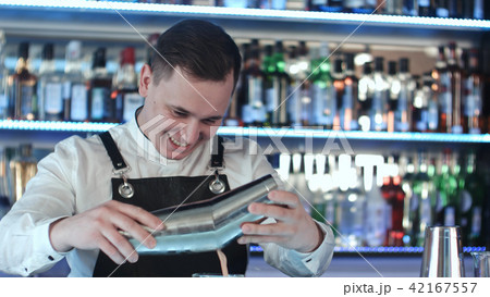 Expert barman is making cocktail at night club 42167557