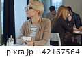 Young beautiful woman drinking coffee at cafe bar 42167564