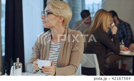 Young beautiful woman drinking coffee at cafe bar 42167564