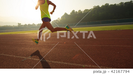 Fitness sportswoman running on sunrise track Fitness sportswoman running on sunrise track 42167794