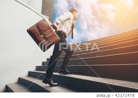 Young businessman upstair on steps to future. Young businessman upstair on steps to future. 42171478