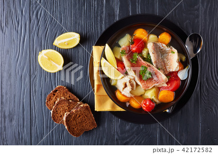 greek psarosoupa in a black bowl 42172582