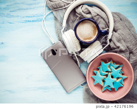 Telephone, headphones, a cup of fragrant cappuccino Telephone, headphones, a cup of fragrant cappuccino 42176196