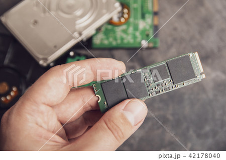 Man's hand holding modern M.2 drive 42178040