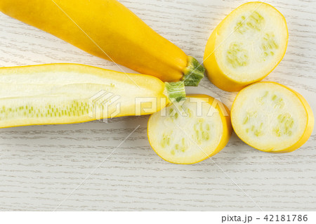 Fresh Raw yellow zucchini on grey wood Fresh Raw yellow zucchini on grey wood 42181786